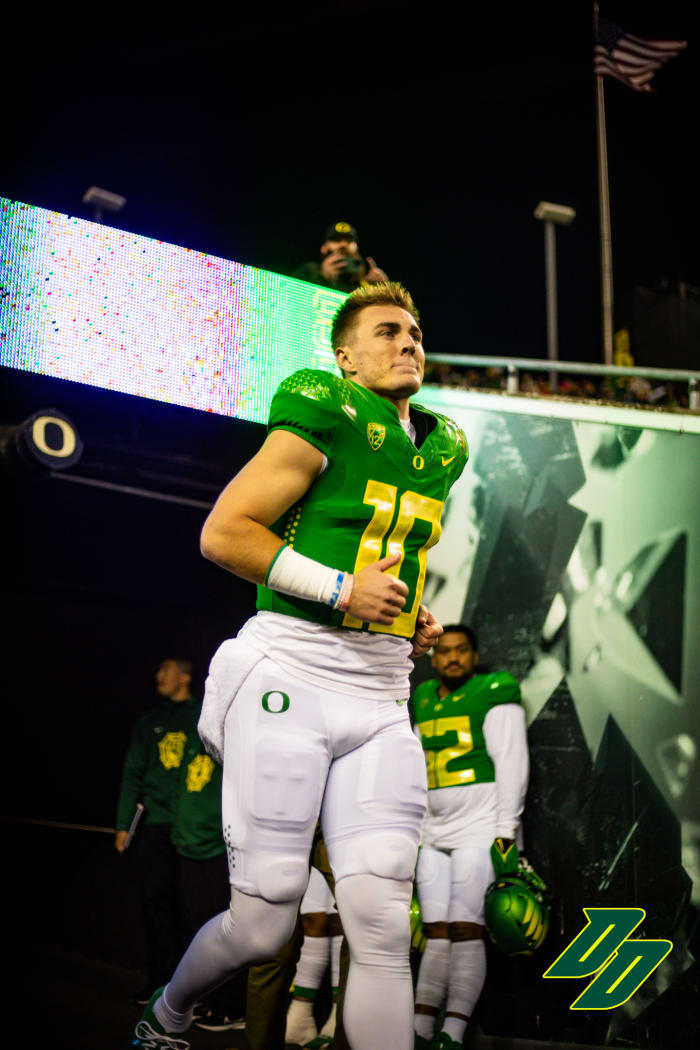 Oregon Ducks quarterback Bo Nix runs out of the tunnel during senior night ceremonies at Autzen Stadium.
